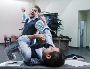 Businessmen fighting in the office